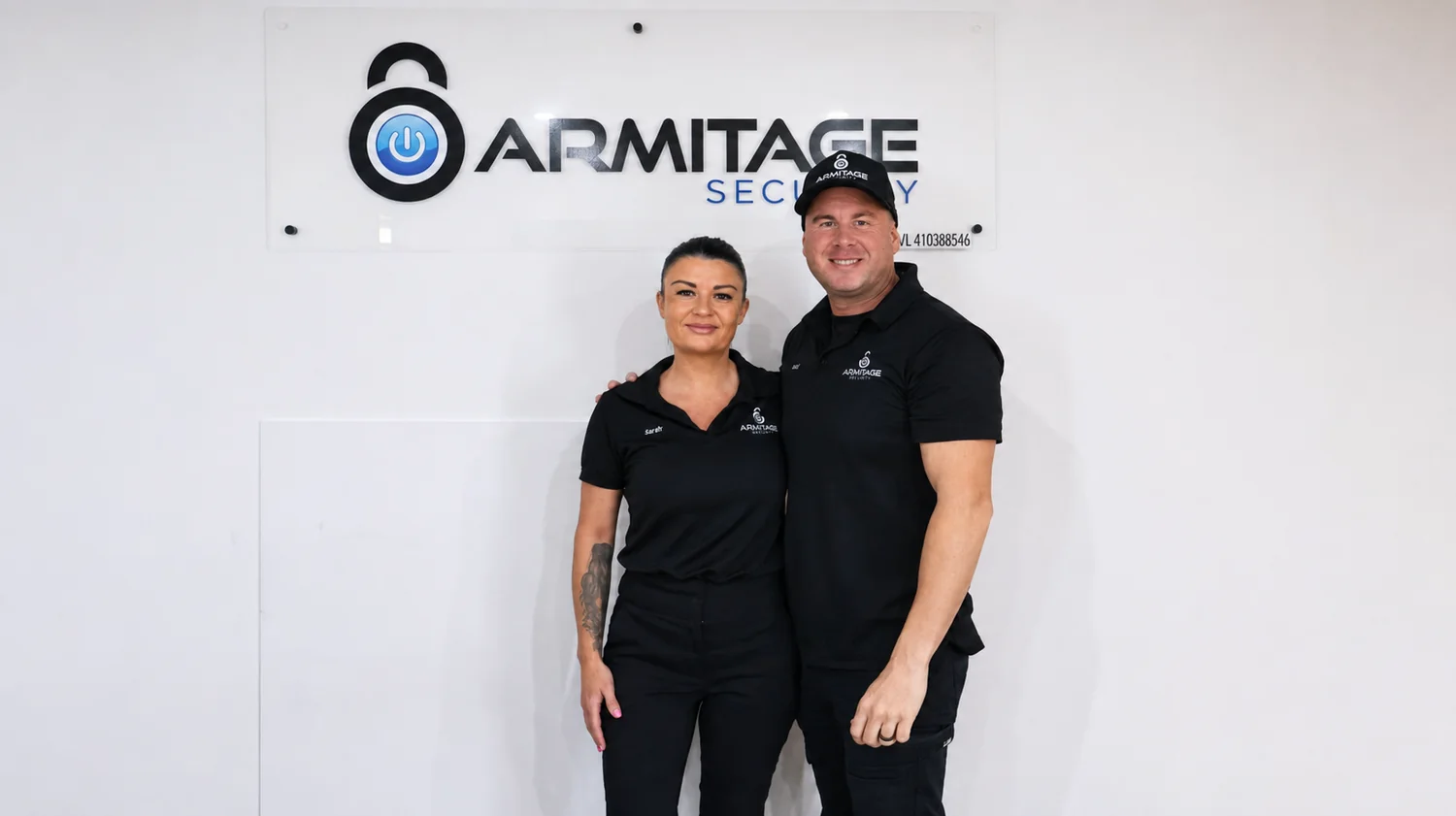 An Armitage Security technician showing a client their new CCTV system at a Nowra business