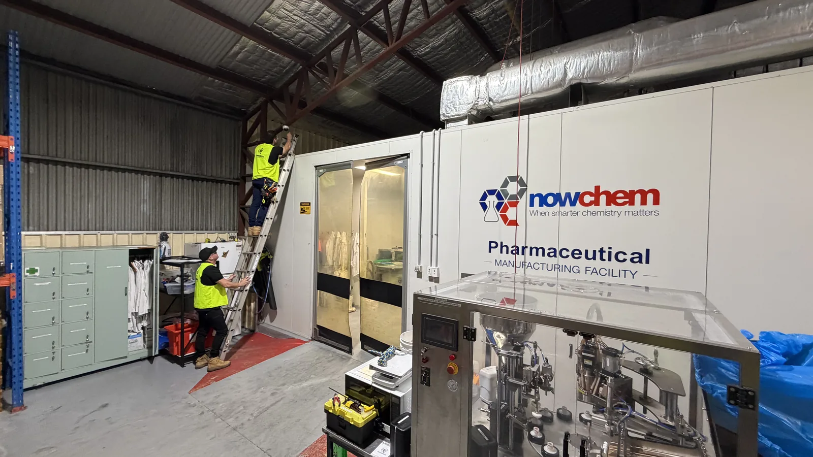 Two Armitage Security technicians installing a security camera at the Nowchem pharmaceutical manufacturing facility in Nowra