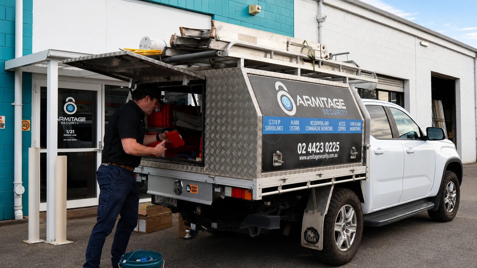 An Armitage Security technician loading the branded ute outside the Nowra office