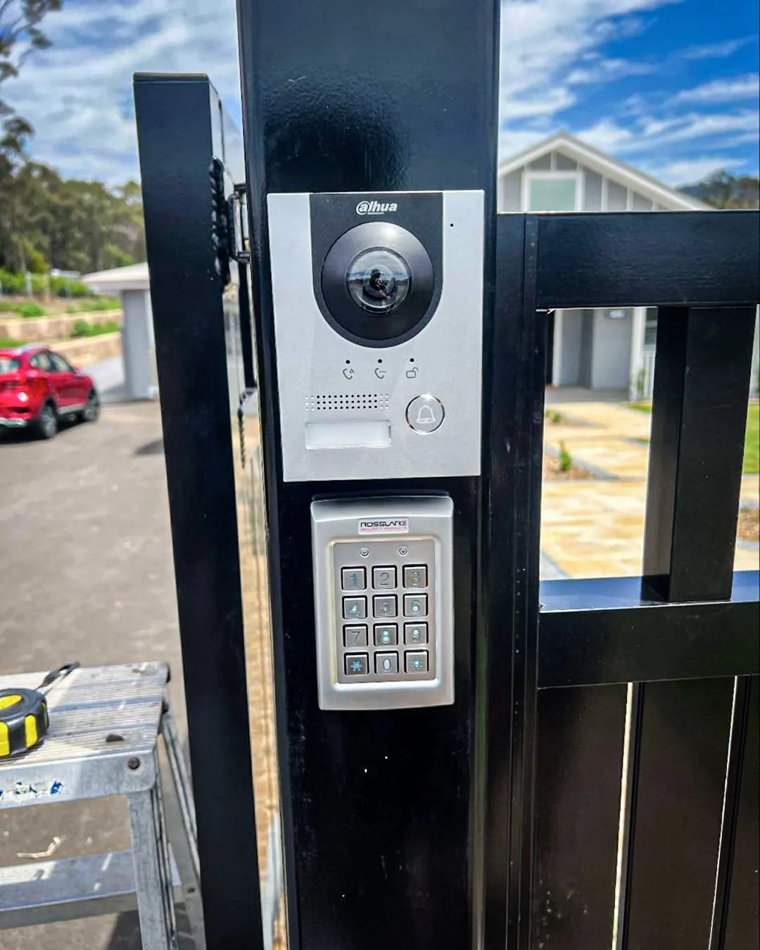 A video intercom and access control keypad mounted on a steel gate