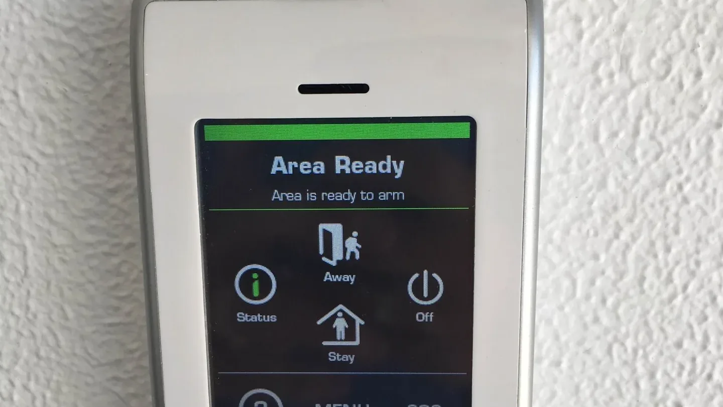An alarm keypad showing the system is ready to arm