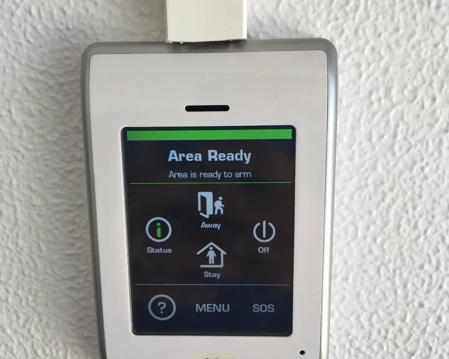 An alarm keypad showing the system is ready to arm