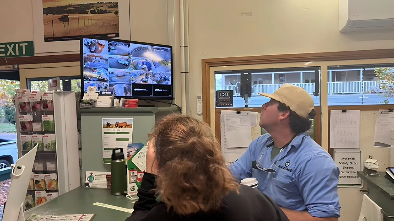 An Armitage Security technician showing a client their new CCTV system at a Nowra business
