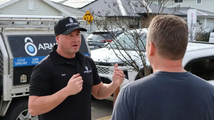 Matt Armitage talking with a client beside the Armitage Security ute